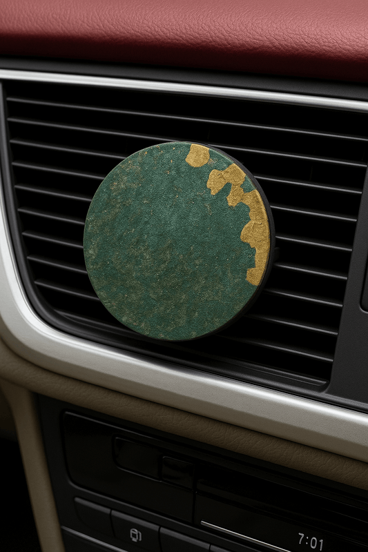 Green circular object on a car's air vent with a maroon interior.