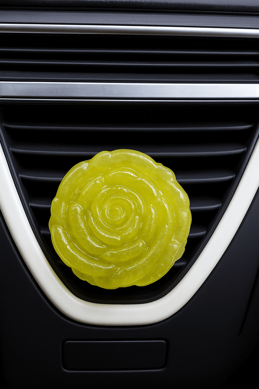 yellow car air freshener in a car's vent