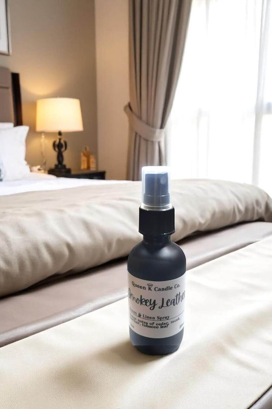 Bottle of 'Smoky Leather' candle spray on a bed in a bedroom setting