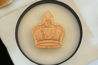 Queen Wickless Candle Jar featuring a crown design in a decorative dish, adding elegance to any space.