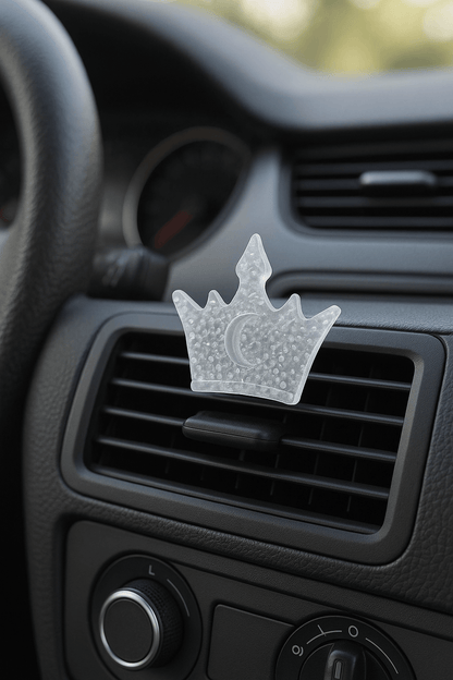 Car air freshener shaped like a crown on a car's air vent.