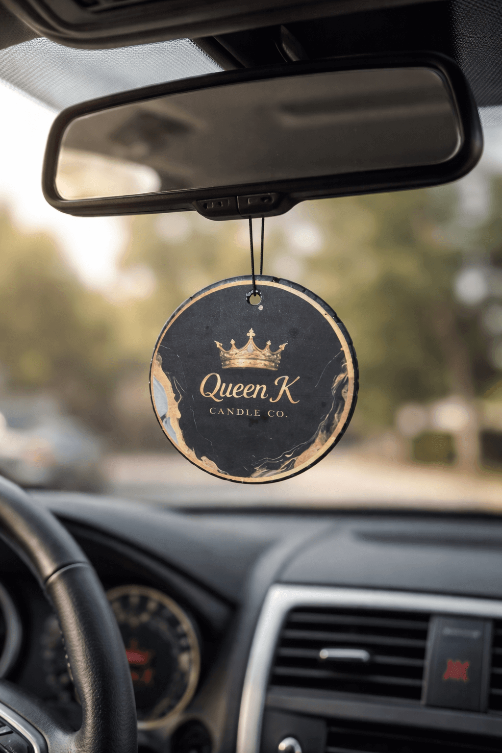 Car air freshener hanging from a car's rear view mirror.