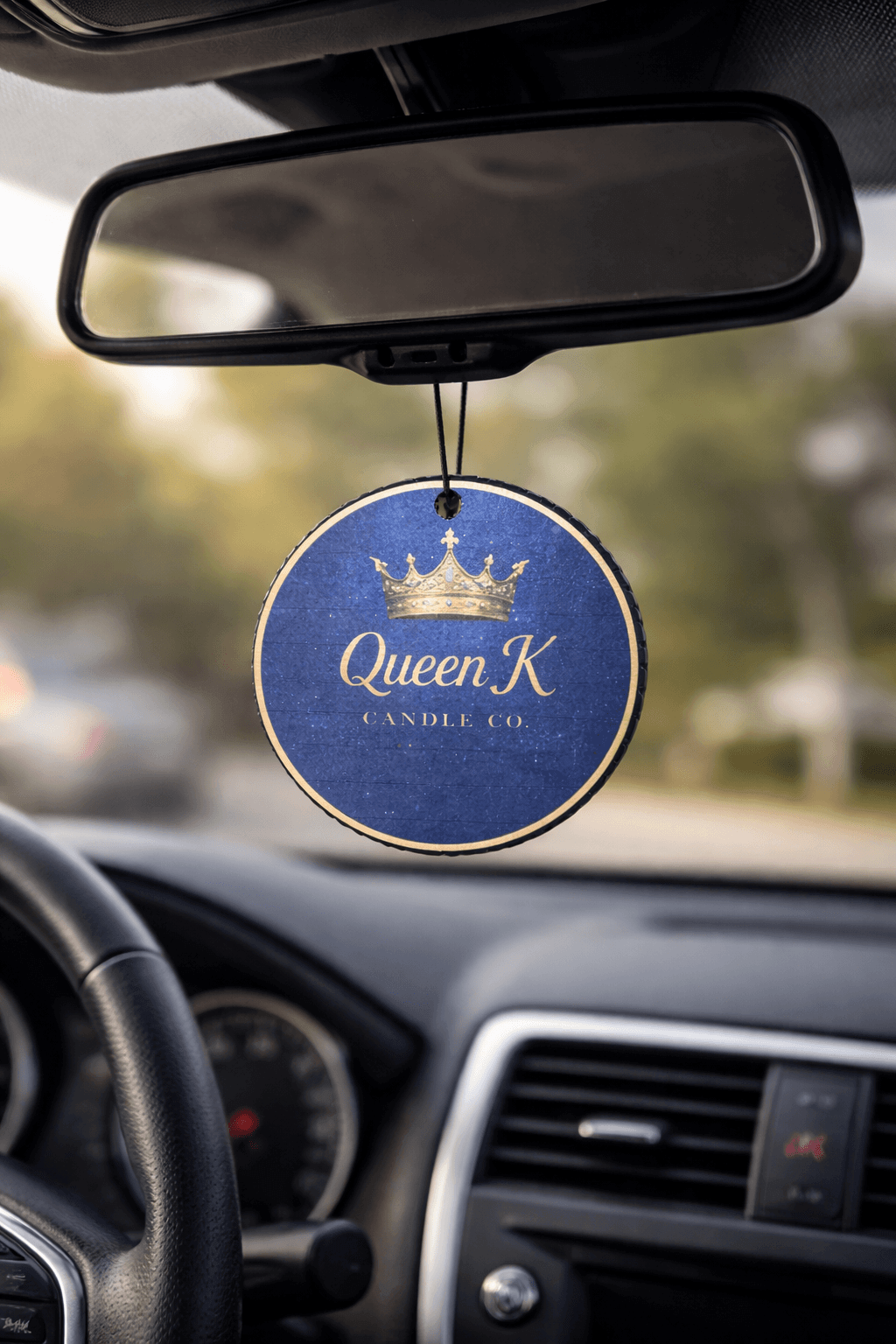 Car air freshener hanging from a car's rear view mirror.