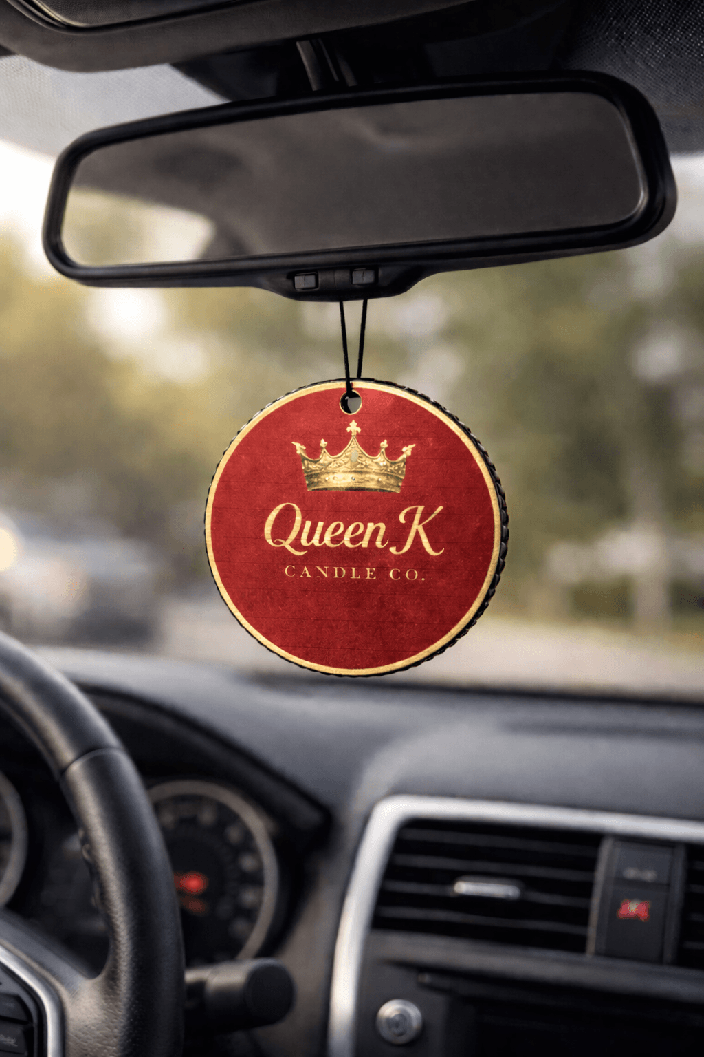 Car air freshener hanging from a car's rear view mirror.