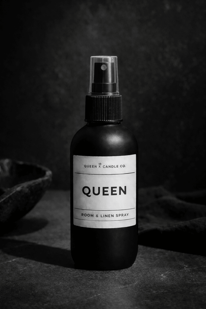 Black bottle of Deluxe Bourbon room & linen spray on a dark background
