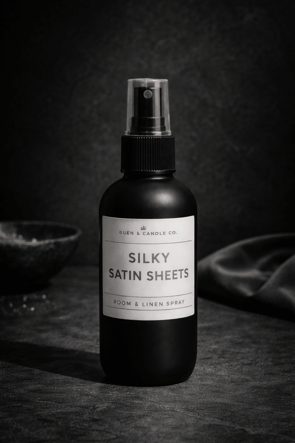 Room and linen spray bottle labeled 'Silky Satin Sheets' on a dark background