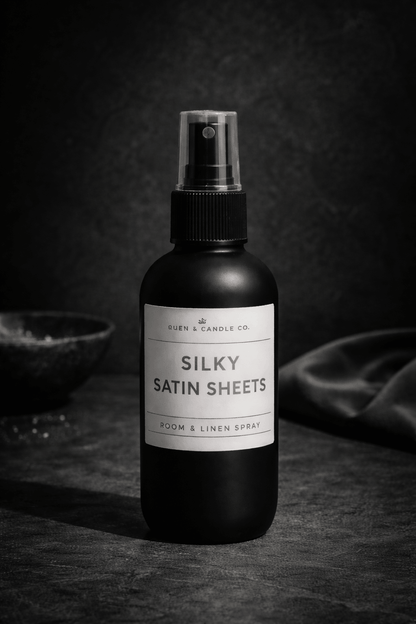 Room and linen spray bottle labeled 'Silky Satin Sheets' on a dark background