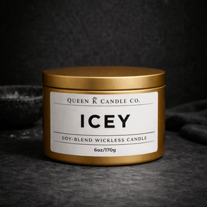 Gold candle jar with 'Icey' label by Queen Candle Co. on a dark background