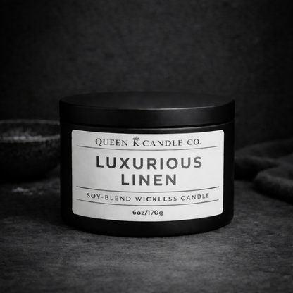 Black candle jar with 'Luxurious Linen' label on a dark background