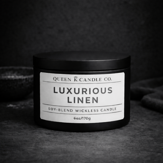 Black candle jar with 'Luxurious Linen' label on a dark background