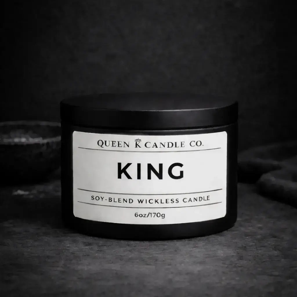 Black candle jar labeled 'King' by Queen K Candle Co. on a dark background