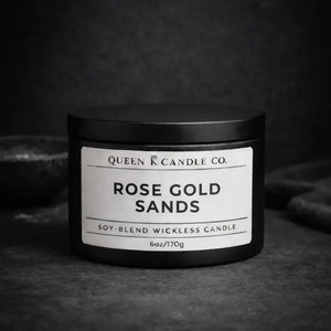 Black candle jar with 'Rose Gold Sands' label on a dark background