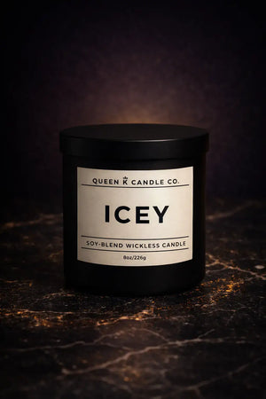 Candle labeled 'Icey' from Queen Candle Co. on a dark textured surface.