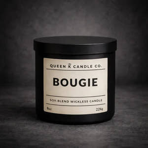 Black candle jar with 'Queen K Candle Co.' label on a dark background