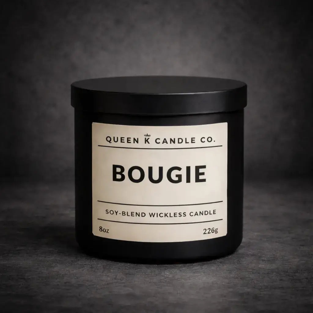 Black candle jar with 'Queen K Candle Co.' label on a dark background