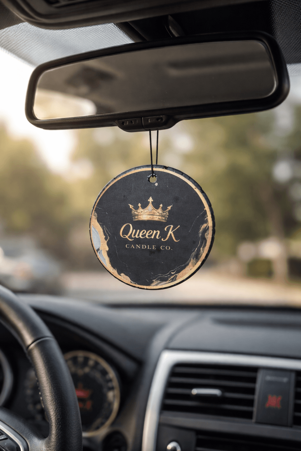 Car air freshener hanging from a car's rear view mirror.