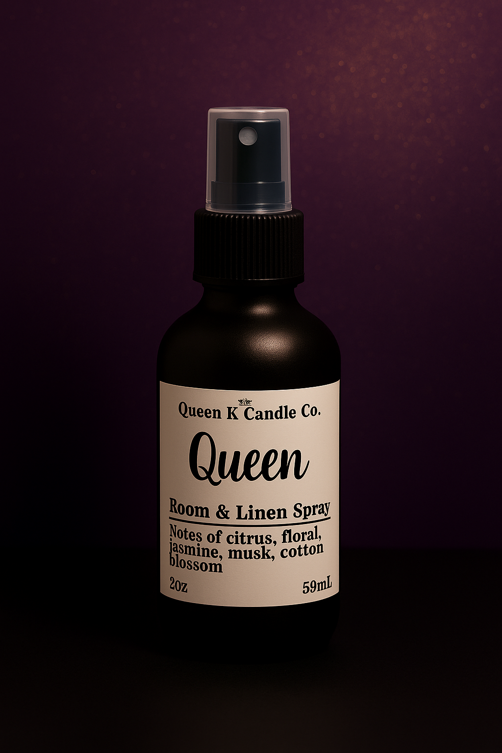 Bottle of Queen K Candle Co. Queen Room & Linen Spray on a dark background
