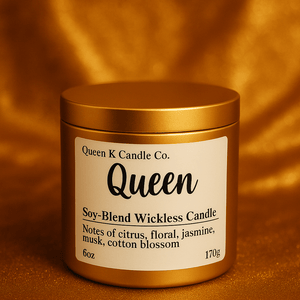 Gold candle jar with 'Queen K Candle Co.' label on a warm brown background