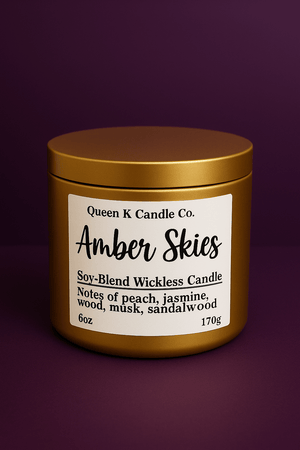 Candle jar labeled 'Amber Skies' by Queen K Candle Co. on a dark purple background