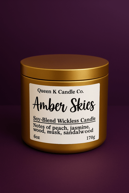 Candle jar labeled 'Amber Skies' by Queen K Candle Co. on a dark purple background