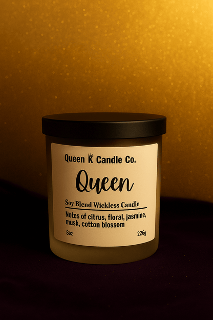 Queen Wickless Candle Jar with notes of citrus, floral, jasmine, and cotton blossom against a golden background.