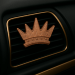 Car air freshener with a crown design on a black background