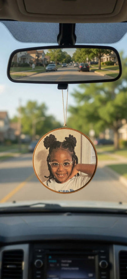 Car air freshener hanging from a car's rear view mirror.